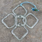 a handmade flower shaped suncatcher from aqua glass recycled from a wine bottle