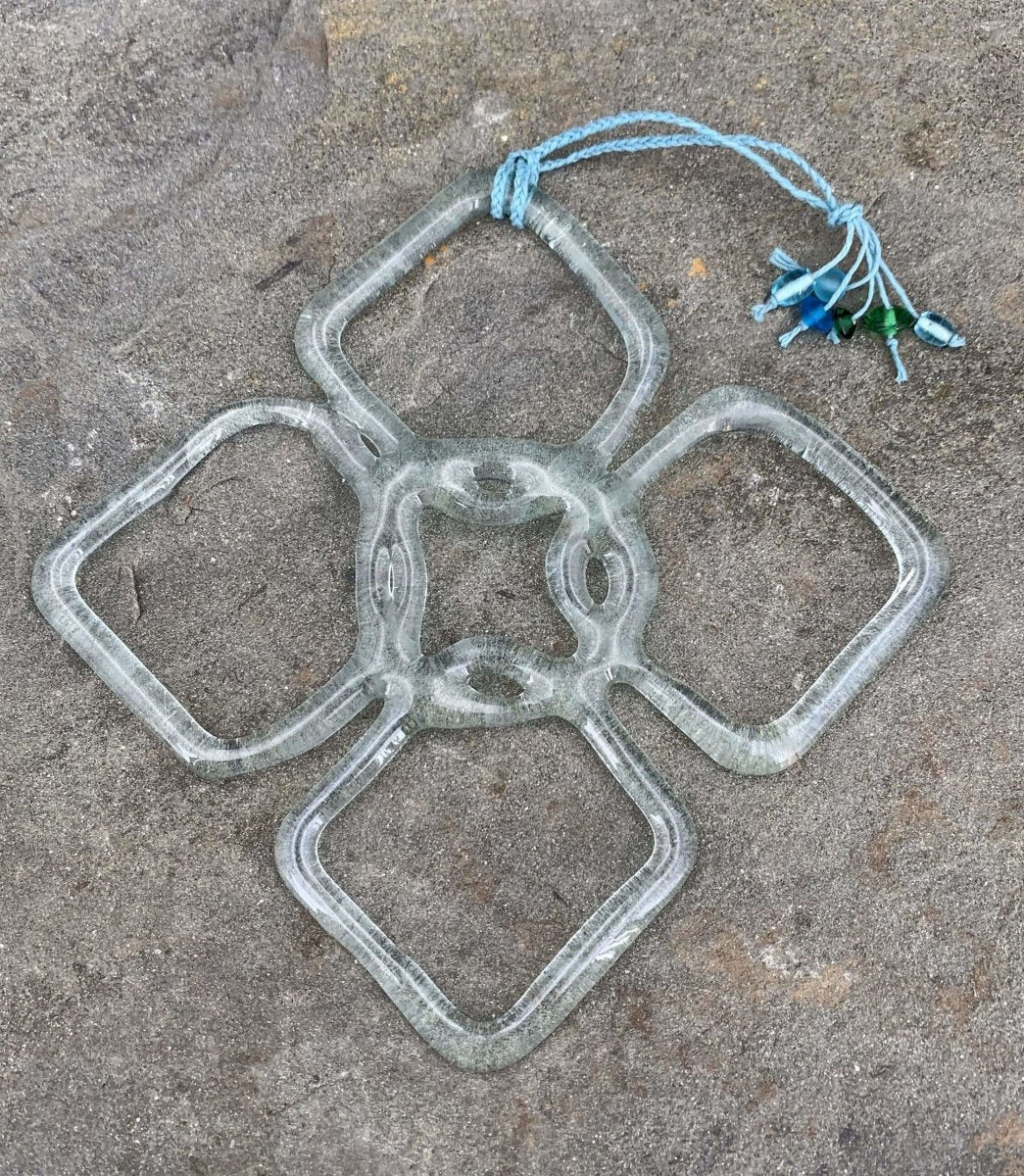 a handmade flower shaped suncatcher from aqua glass recycled from a wine bottle