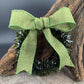 a handmade green glass wreath from a recycled wine bottle with a green ribbon bow
