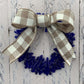 a handmade blue recycled glass wreath with a tan and white plaid bow