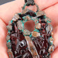 a handmade pendant from recycled glass that has been electroformed with copper and had a patina applied