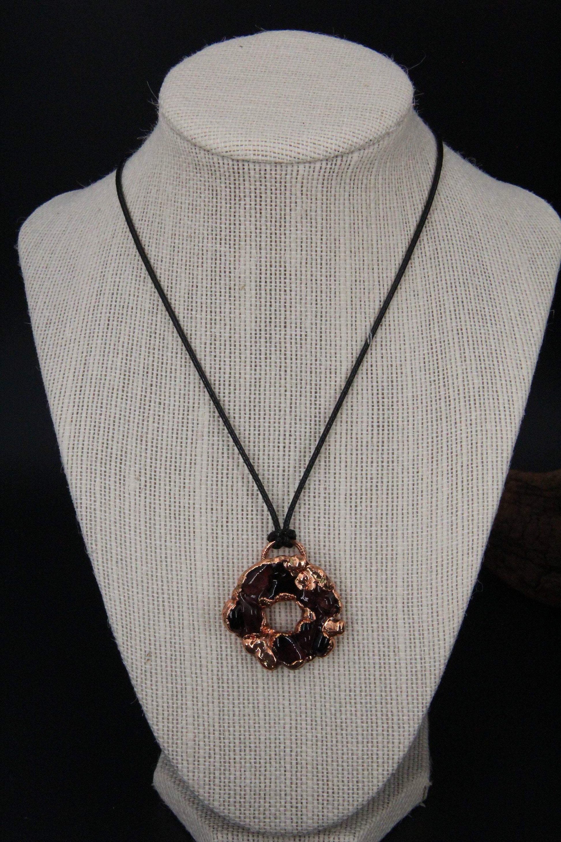 a handmade pendant from recycled glass that has been electroformed with copper